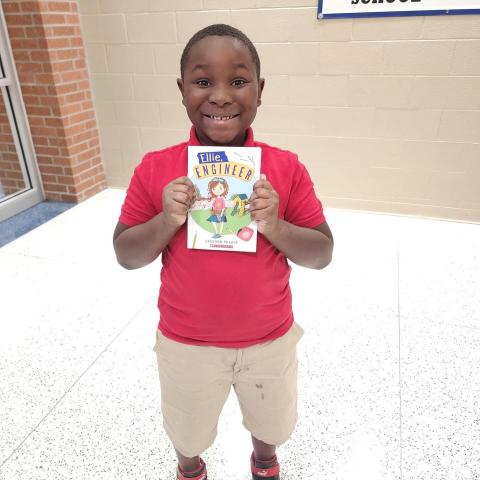 Young Boy Smiling with a Book